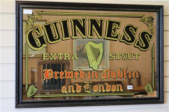 A Guinness advertising mirror W.94cm